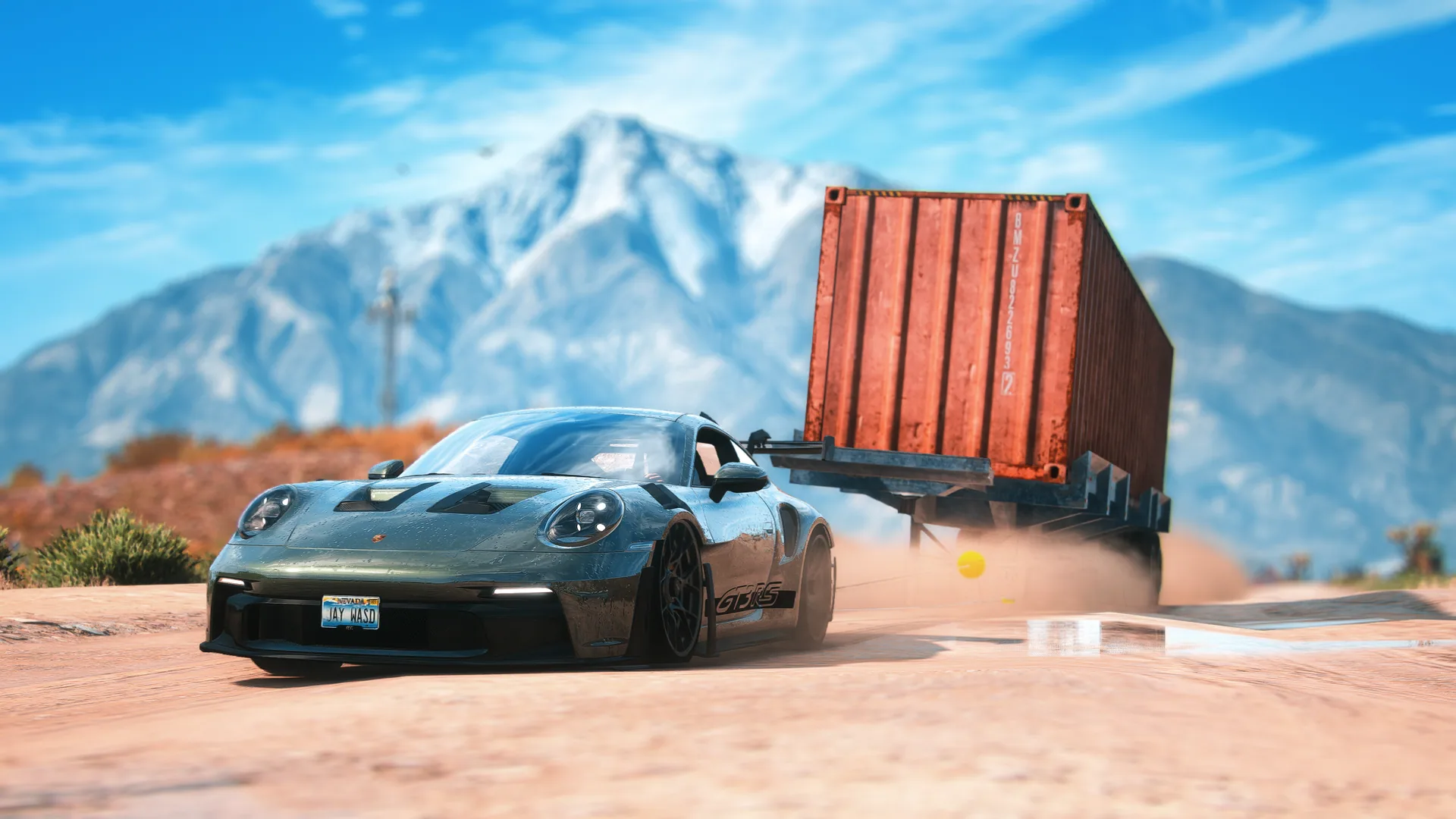 A sports car towing a heavy orange container
