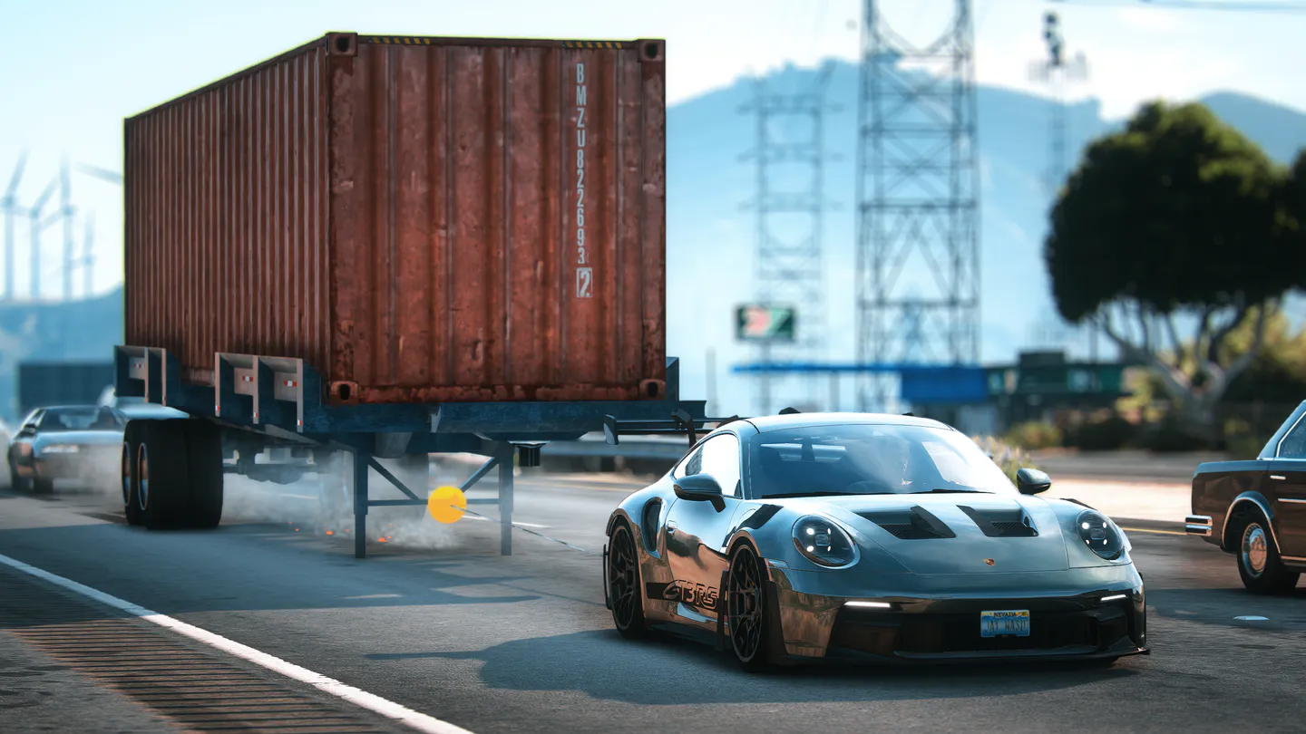 A yellow endpoint attached to a container trailer as a sports car drives past